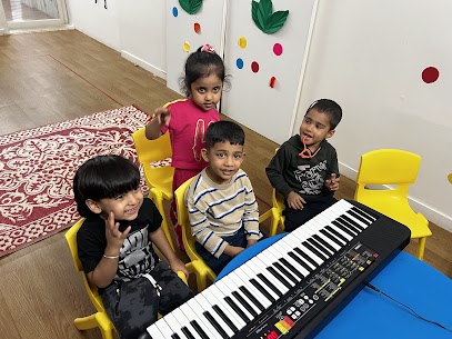 Teacher guiding a child at the piano during a music class at Whiskar Music School, Kalyani Nagar